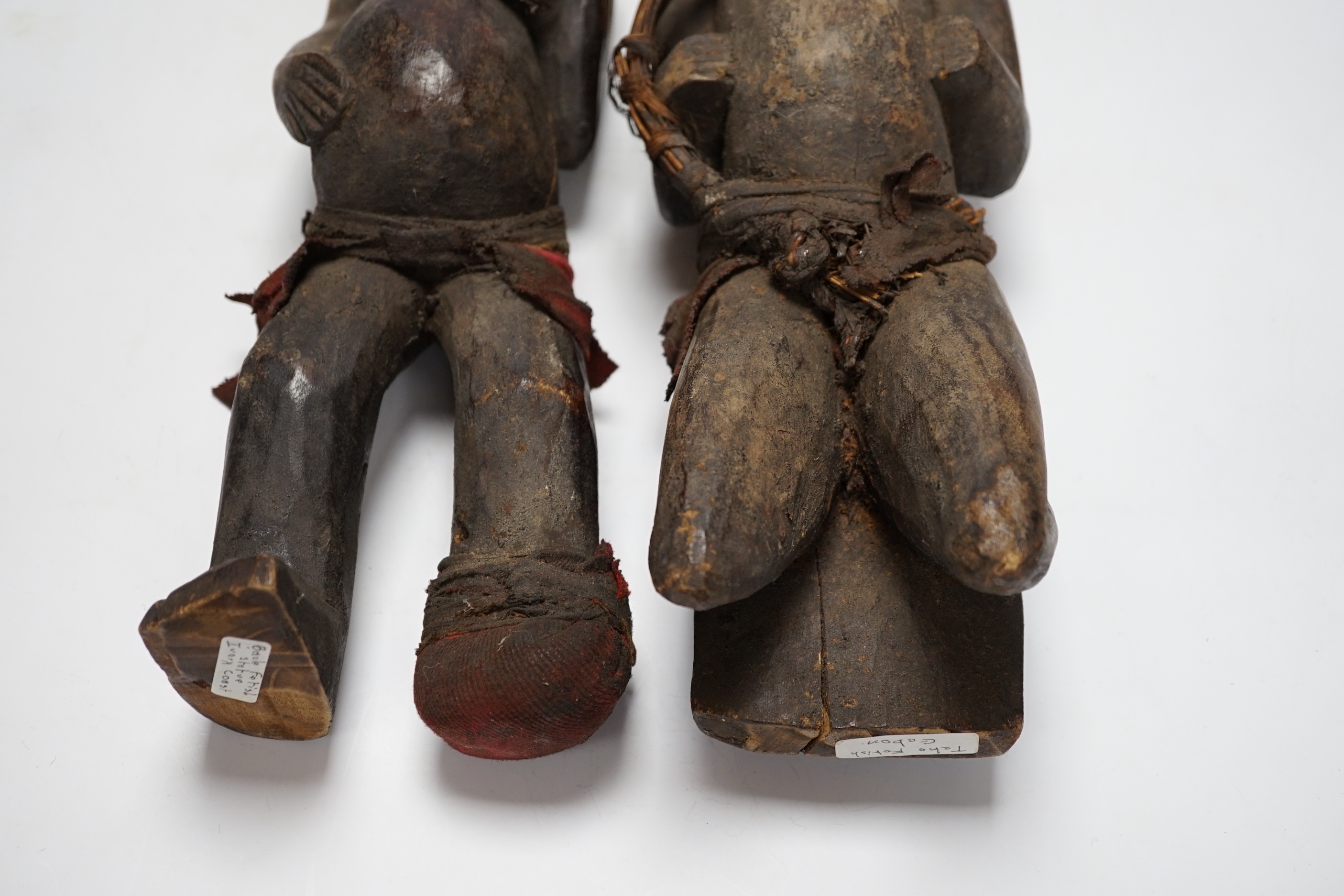 A pair of African tribal carved figures, tallest 53cm